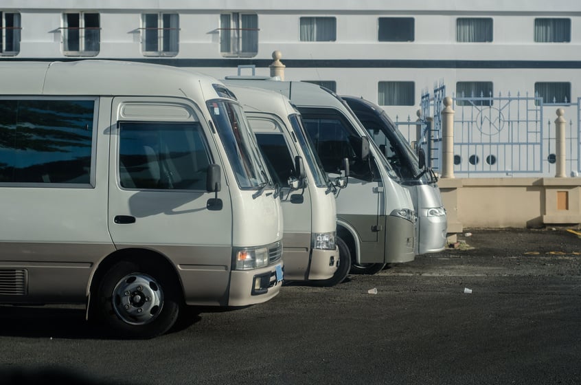 row of tour buses wait near cruise ship