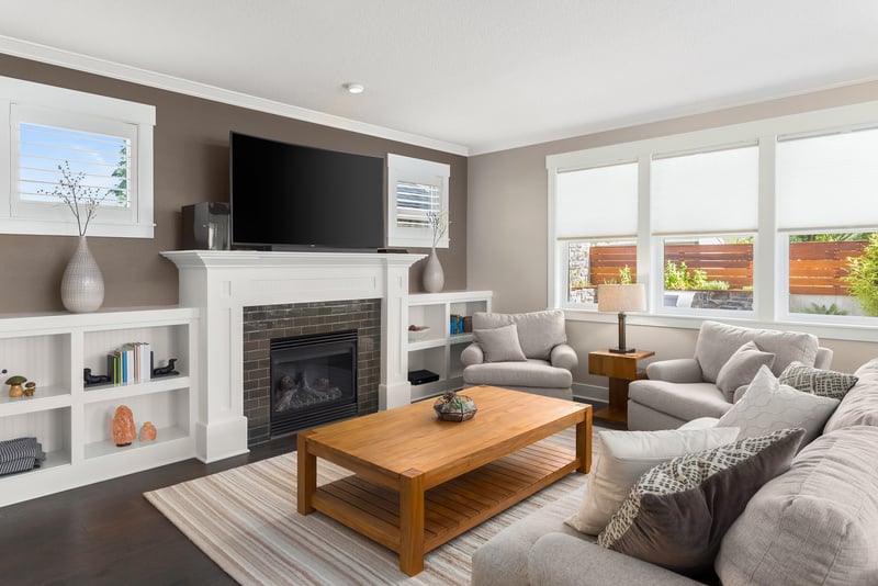 Beautiful living room interior with hardwood floors and fireplace in new luxury home.